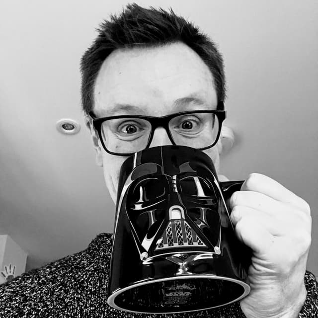 Image of Matt Moore drinking from a Darth Vader mug